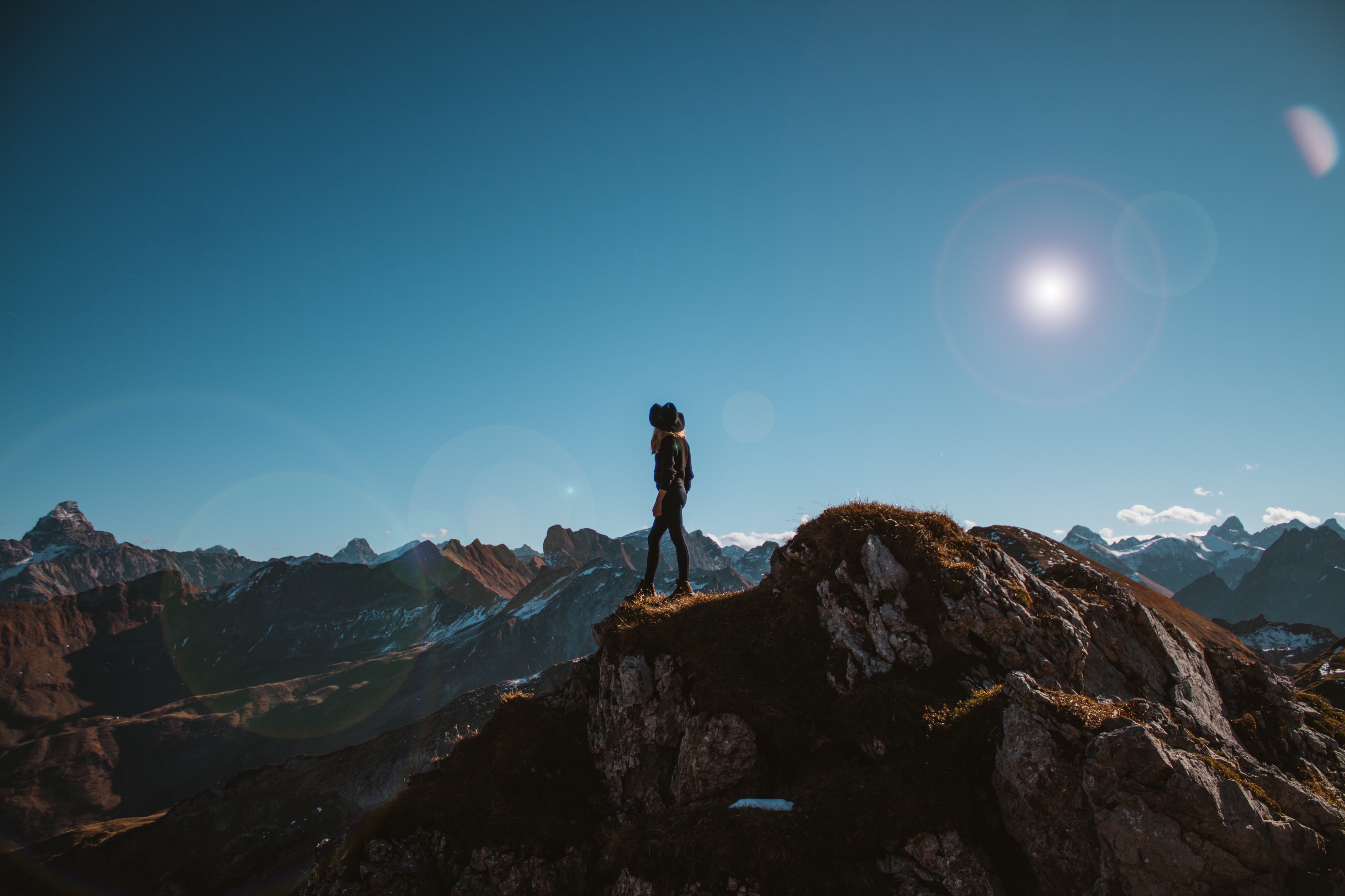 A woman standing on a mountaintop.
