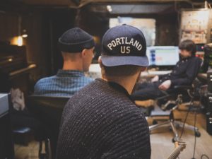 Three people working in a recording studio.
