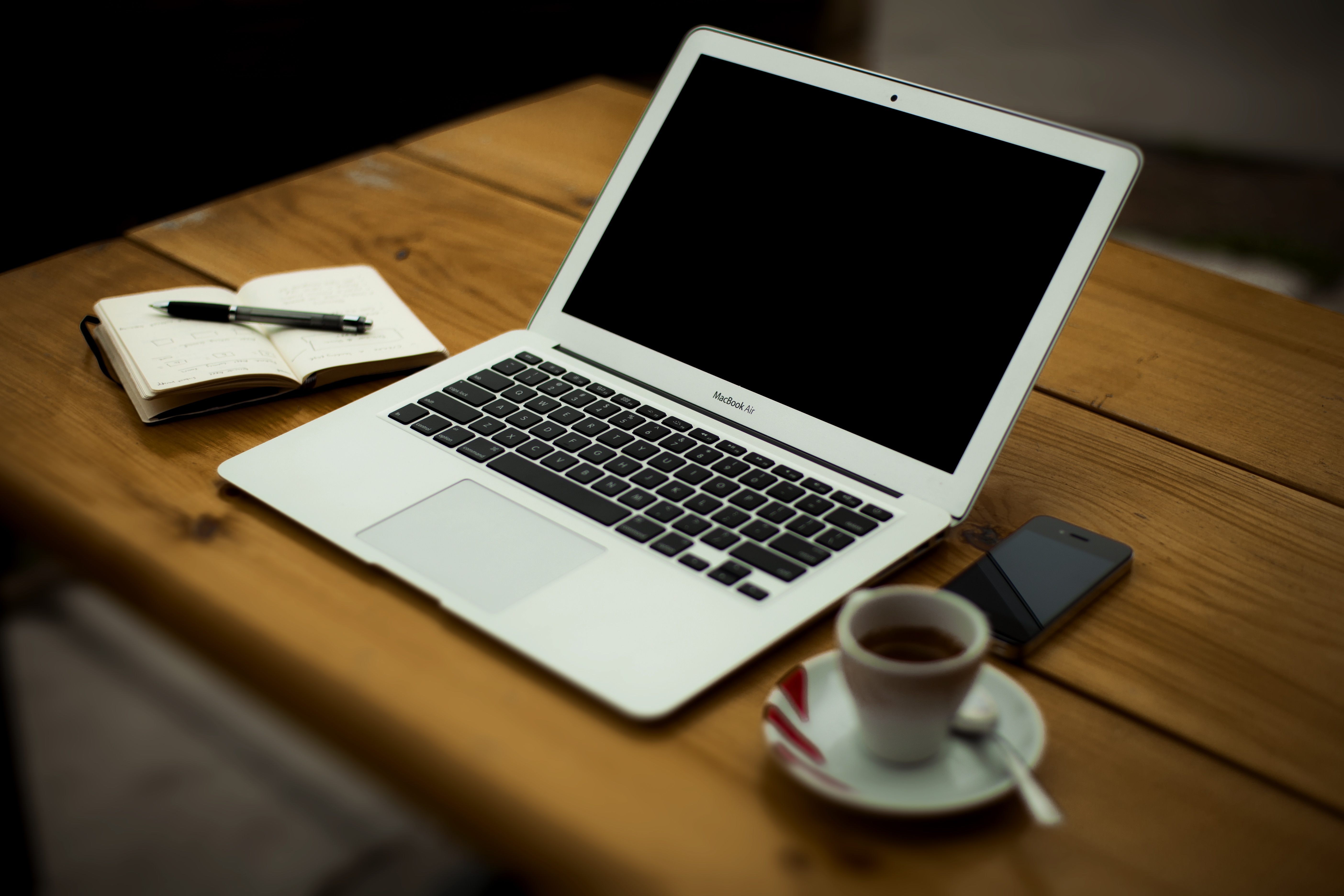 A laptop on a wooden desk.