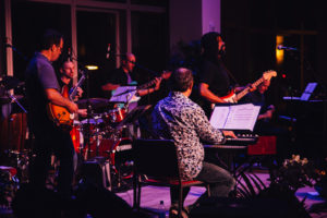 An ensemble performs on a stage.