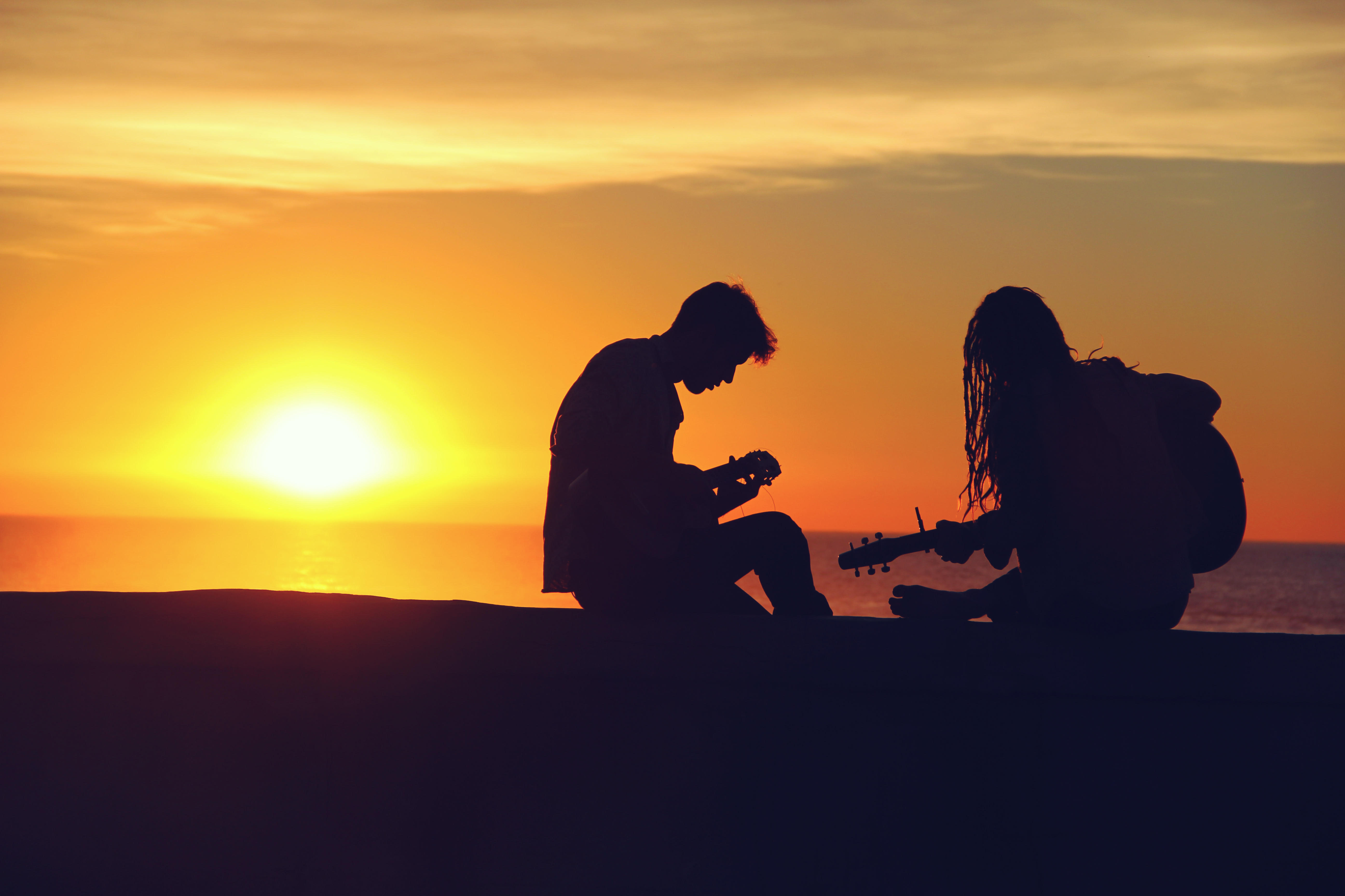 Two people collaborate writing a song.