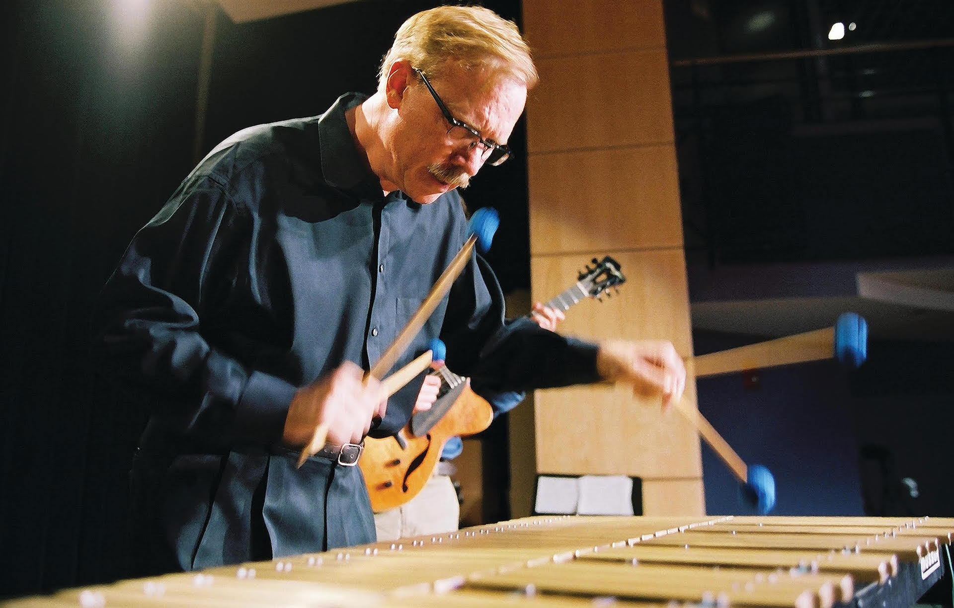 Jazz legend Gary Burton is pictured playing the vibraphone.