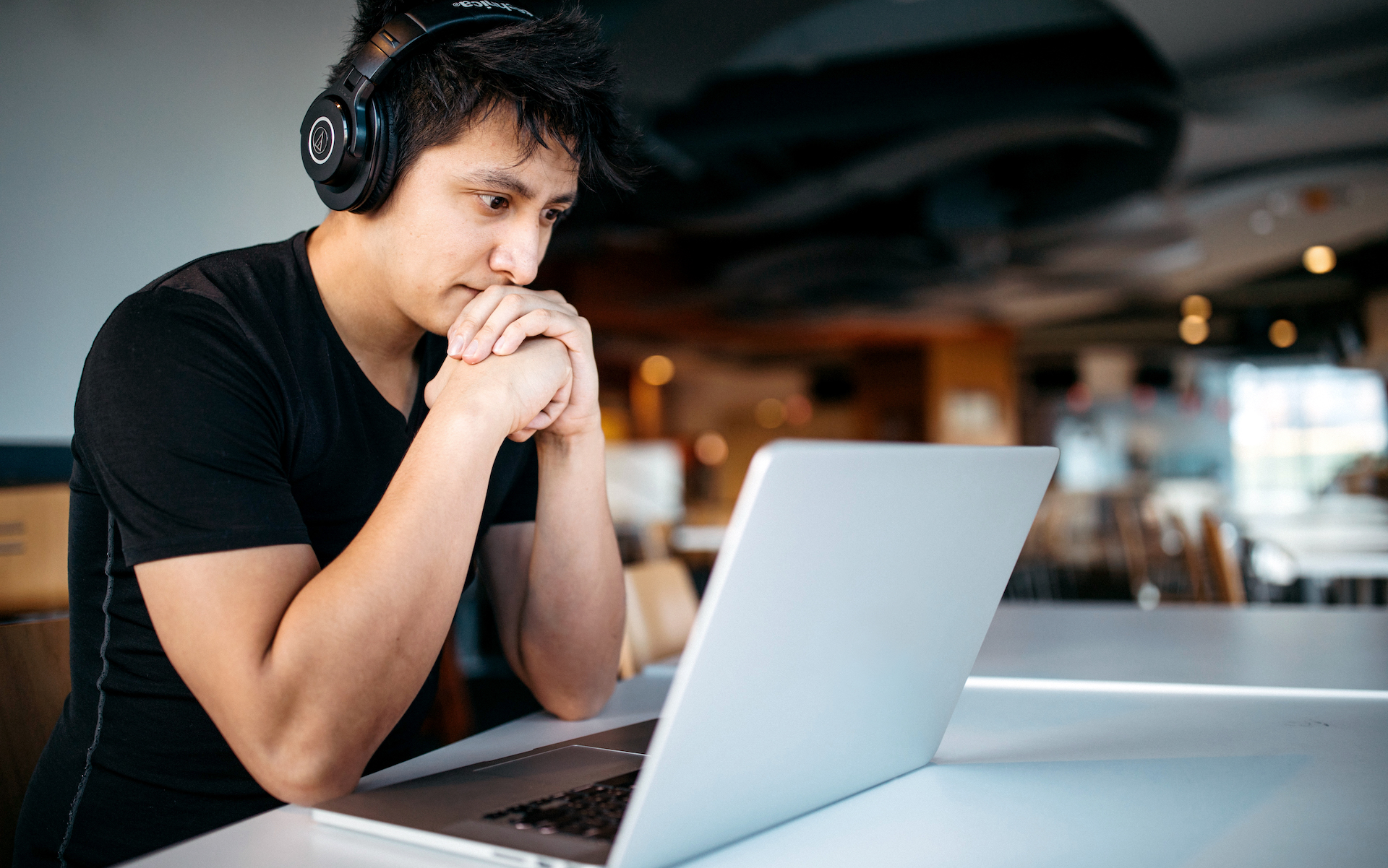 A musician sits at his computer creating his website.