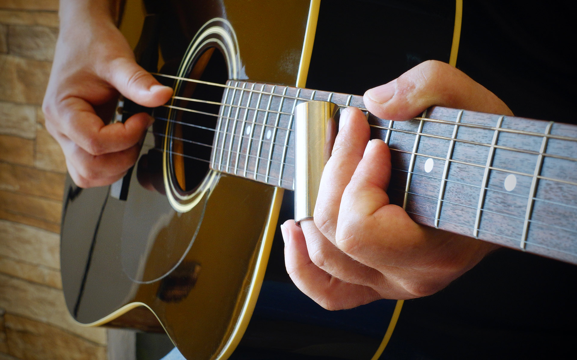 Acoustic blues guitar with a slide.