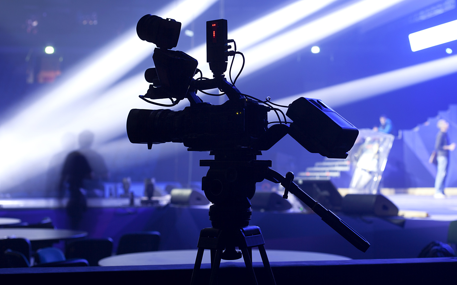 A professional video camera filming a concert