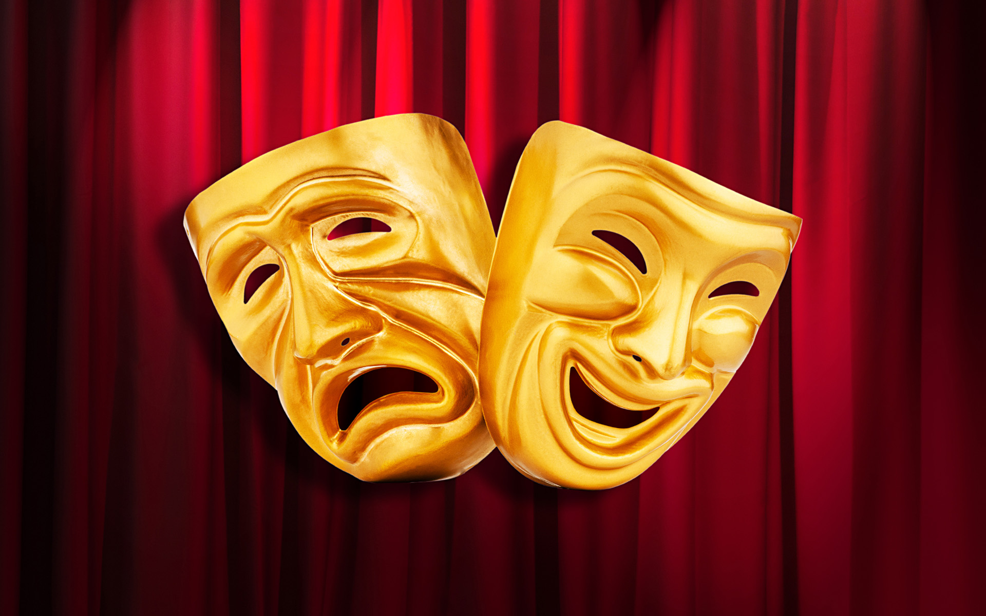 The tragedy and comedy masks with a red curtain backdrop.