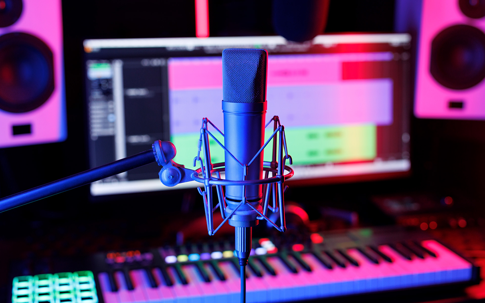 A recording microphone with an electronic keyboard and a computer monitor with a DAW program on the screen in the background.