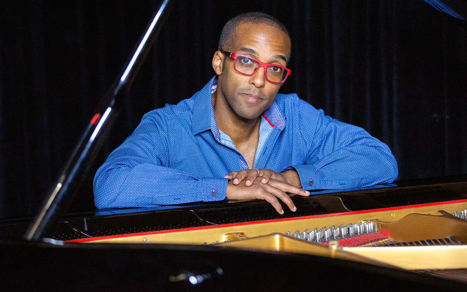 Berklee Online instructor Kevin Harris sits at his piano.