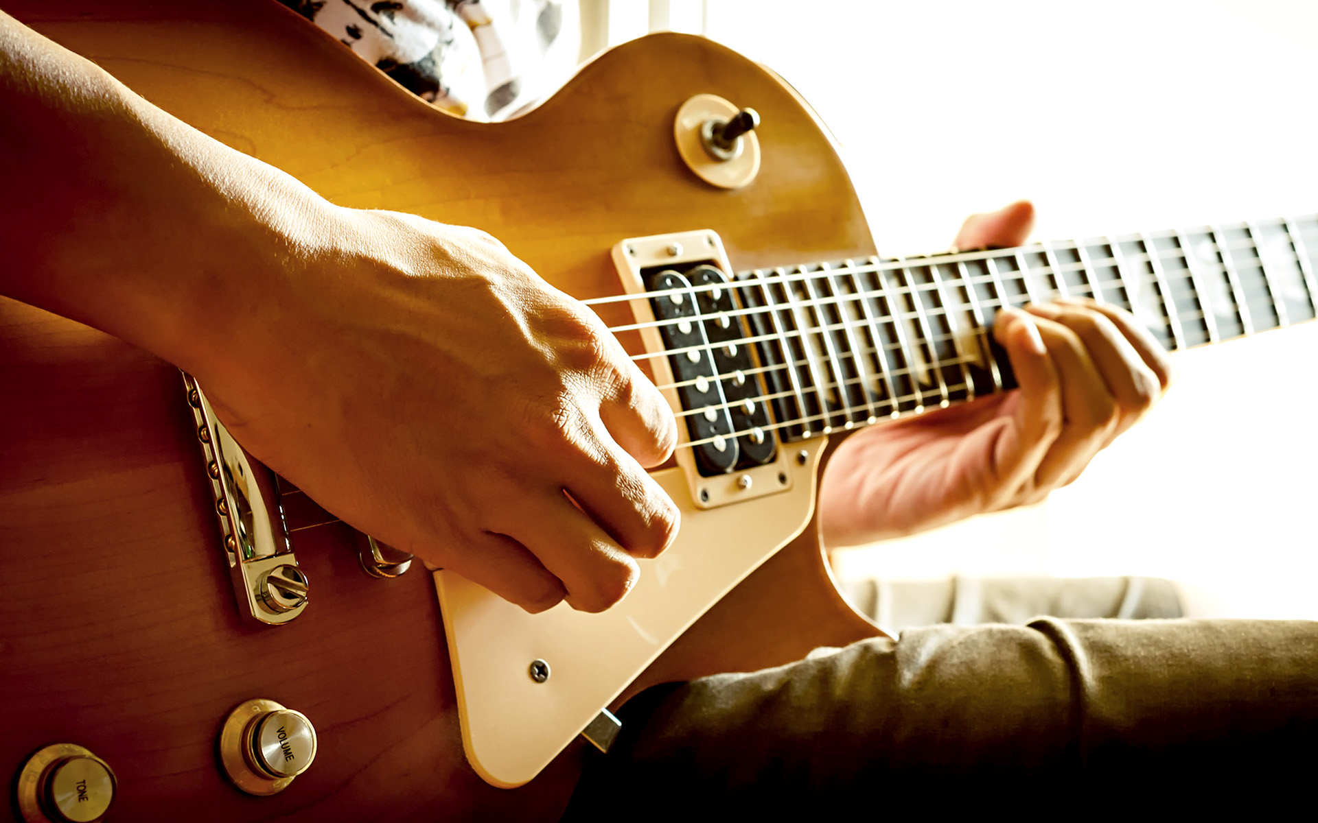 Person playing their guitar scales