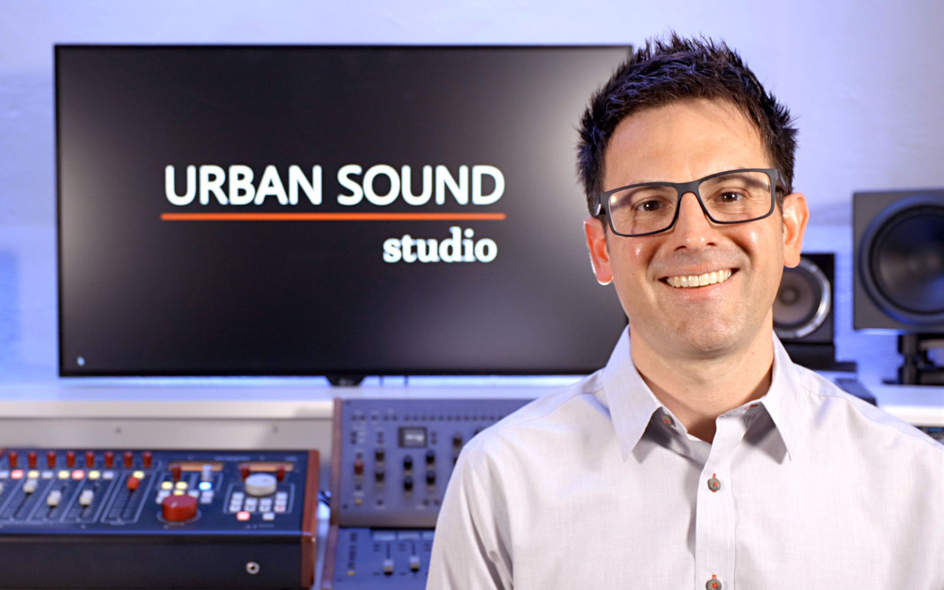 Todd Urban with a video screen that says "URBAN SOUND studios" in the background