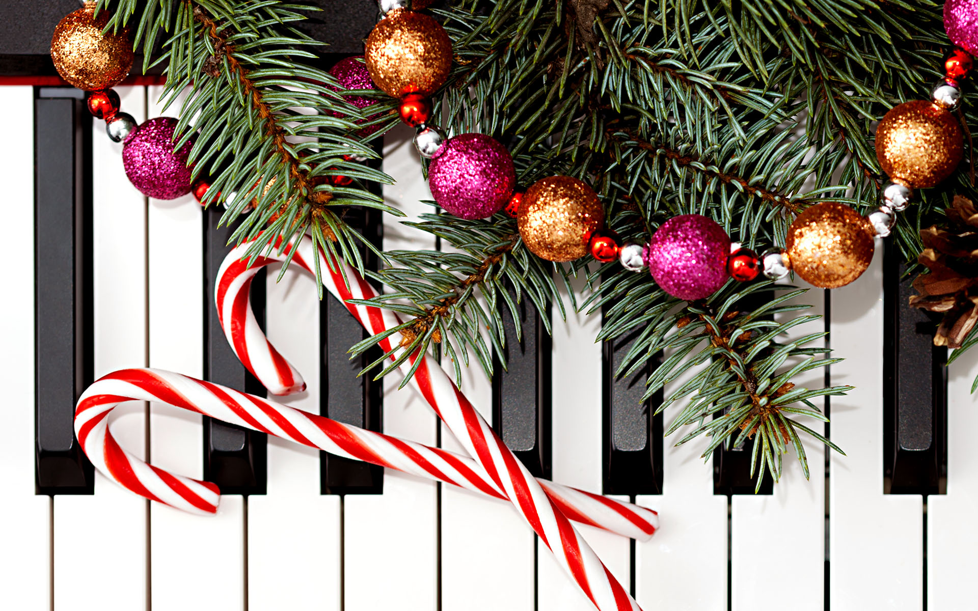 Christmas Music Favorites from Berklee Gospel Keyboard Instructors The keys of a piano or organ are shown, with candy canes, garland, and evergreens spreading onto the keyboard, to represent holiday music.