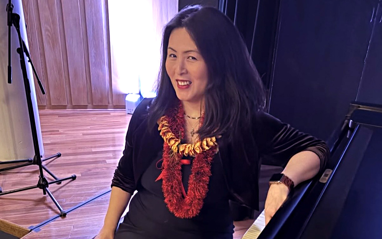 Karen Watanabe sitting at a piano 