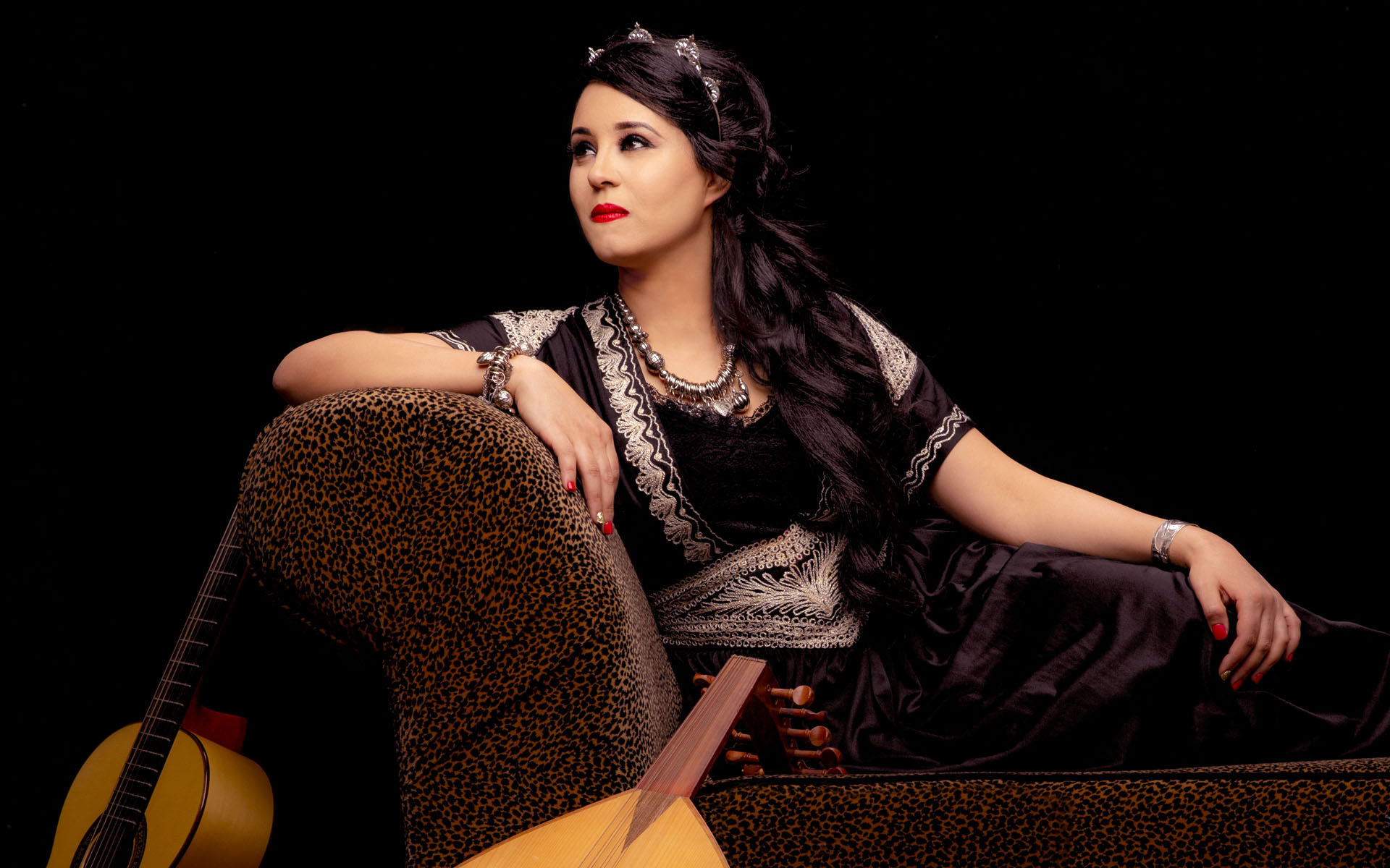 Meriem Ben Amor sitting on a lounge chair with her instruments