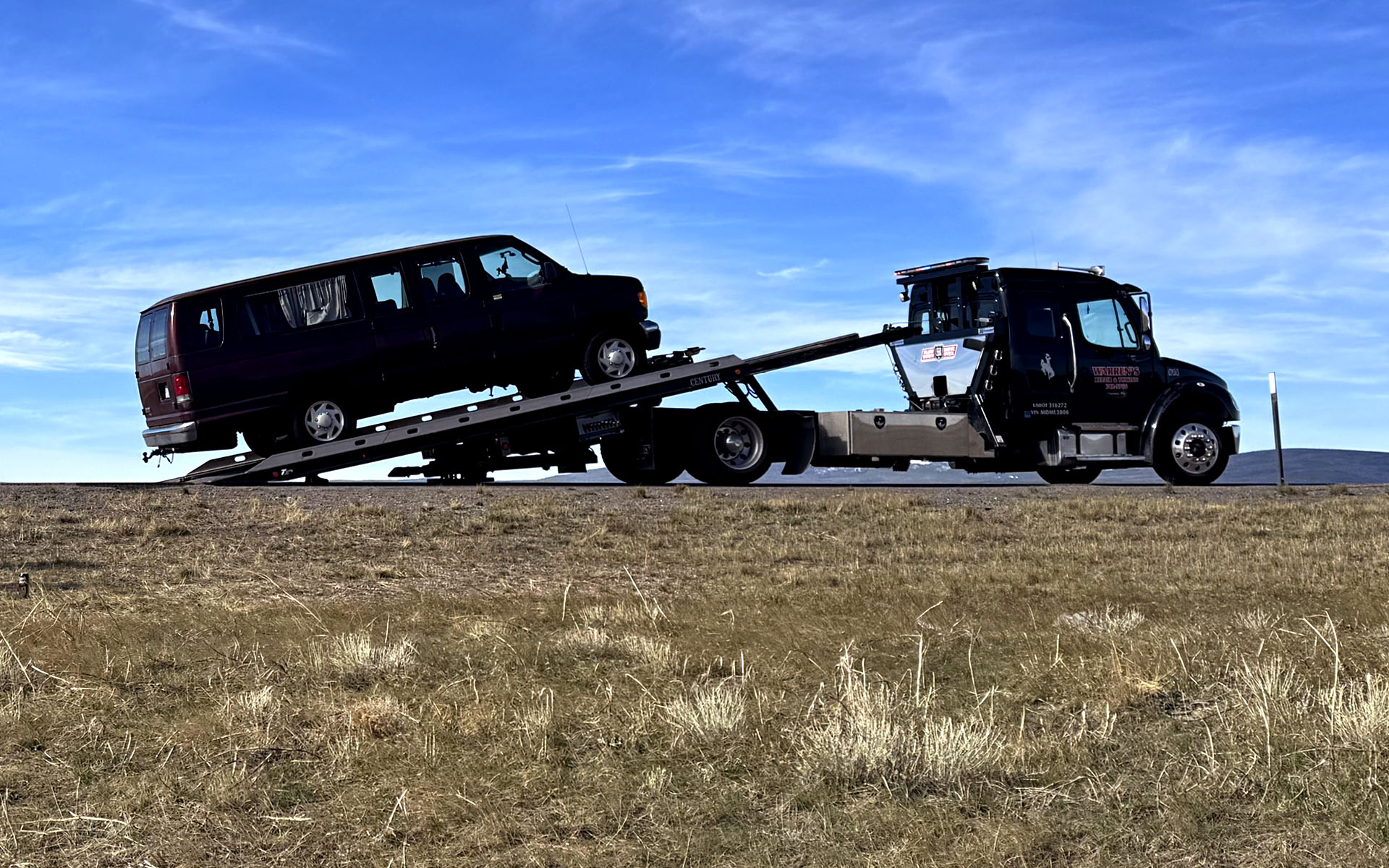 Astronoid's tour van being loaded onto a tow truck