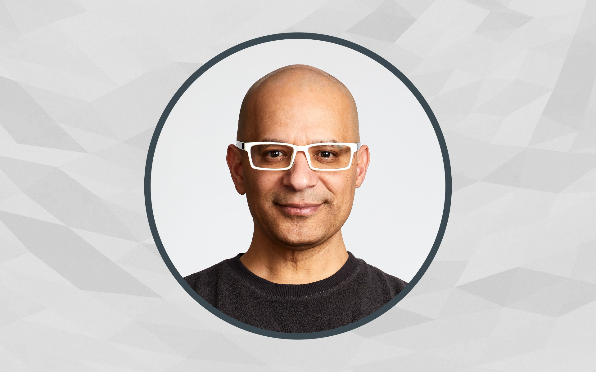 A portrait of Berklee Online instructor Rodney Alejandro framed inside of a circle, with a gray background.