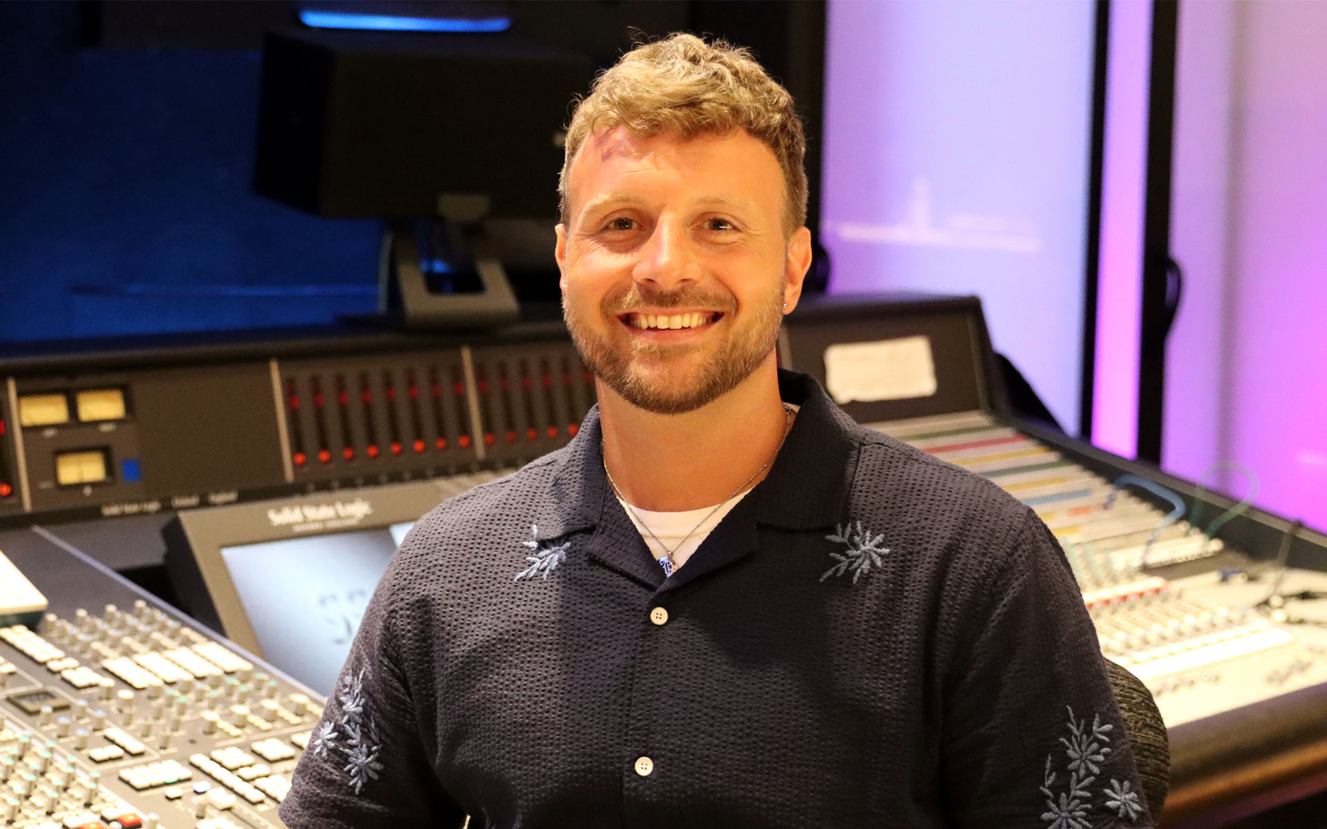 A picture of Colin Foley in a recording studio.