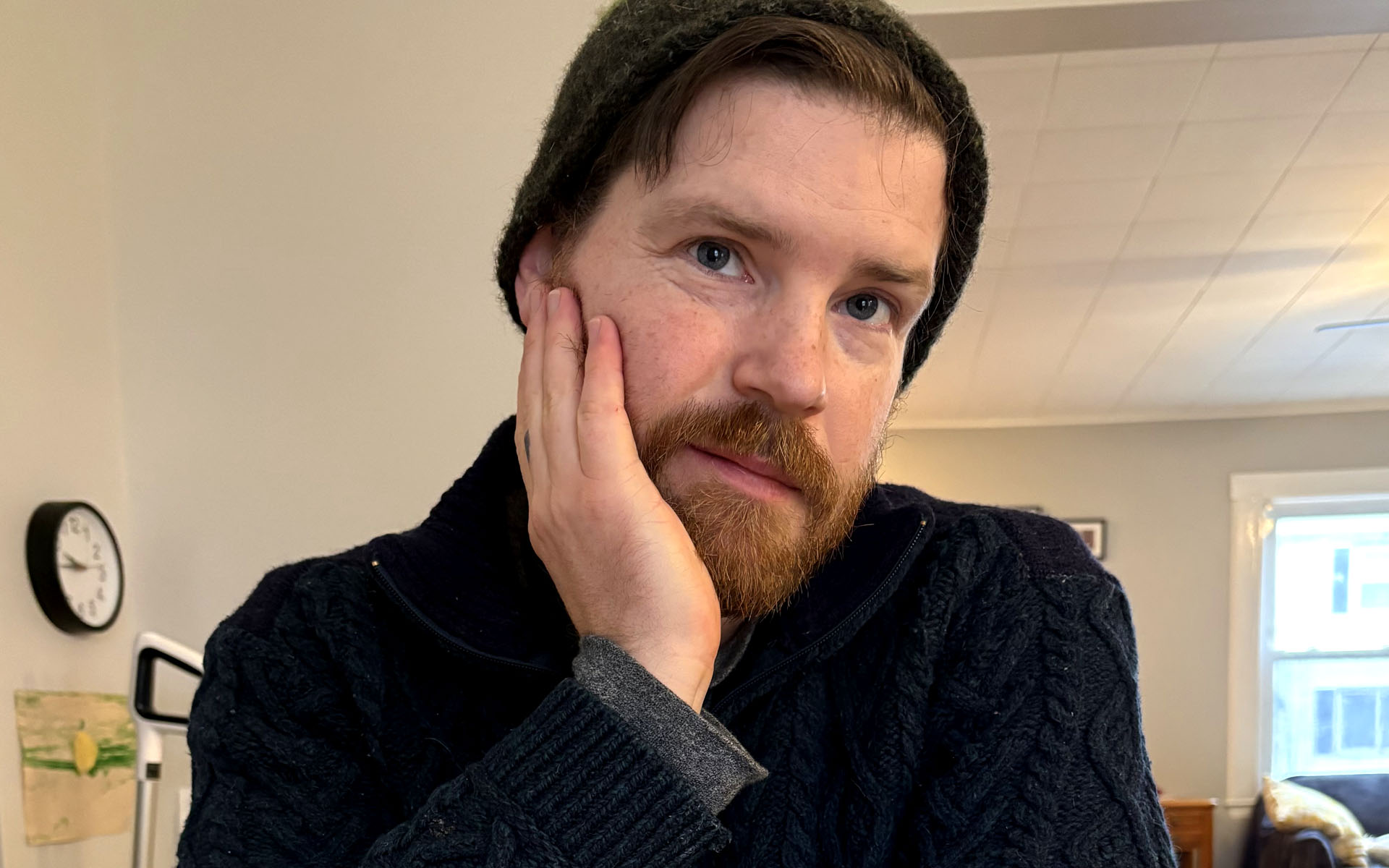 A picture of Paul with his left hand on his face.